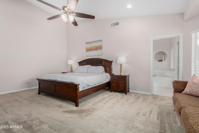 bedroom featuring light carpet, baseboards, visible vents, ensuite bath, and ceiling fan