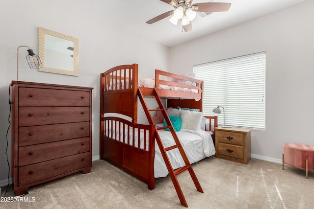 bedroom featuring a ceiling fan, light colored carpet, and baseboards