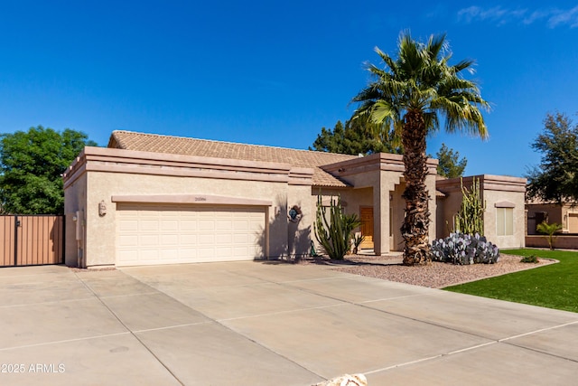 view of front of home featuring concrete driveway, an attached garage, and stucco siding