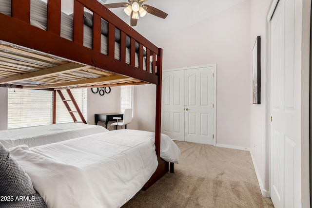 bedroom featuring carpet, a high ceiling, and baseboards