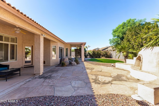 view of patio / terrace with fence private yard and ceiling fan