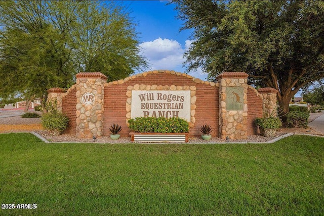 community sign featuring a lawn