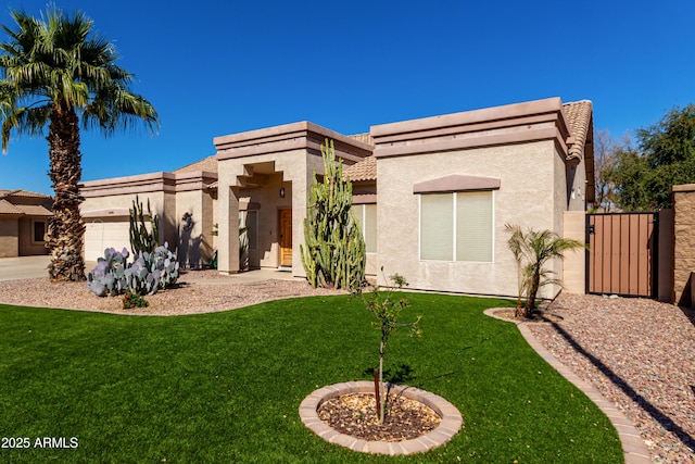 view of front facade featuring a garage, a gate, a front lawn, and stucco siding