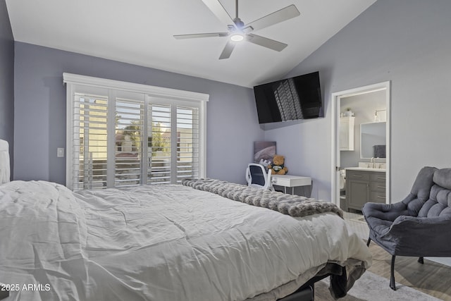 bedroom featuring vaulted ceiling, ensuite bathroom, ceiling fan, sink, and light hardwood / wood-style floors