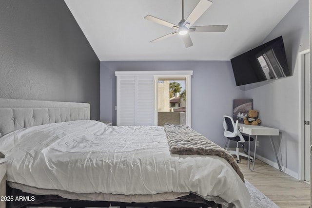 bedroom featuring light wood-type flooring, ceiling fan, and vaulted ceiling