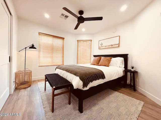 bedroom with ceiling fan and hardwood / wood-style flooring