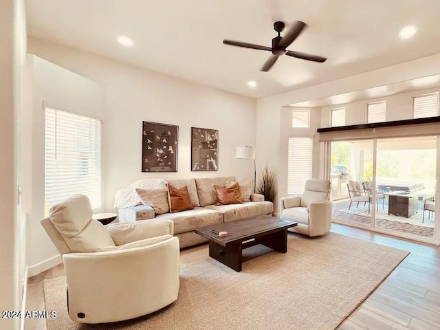 living room with hardwood / wood-style floors and ceiling fan