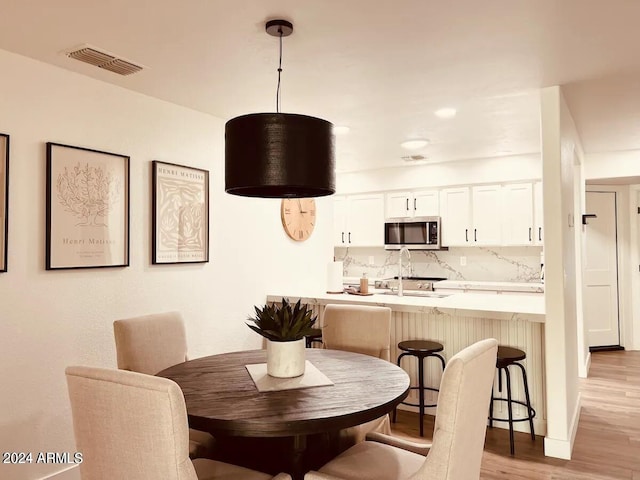 dining room with light hardwood / wood-style flooring