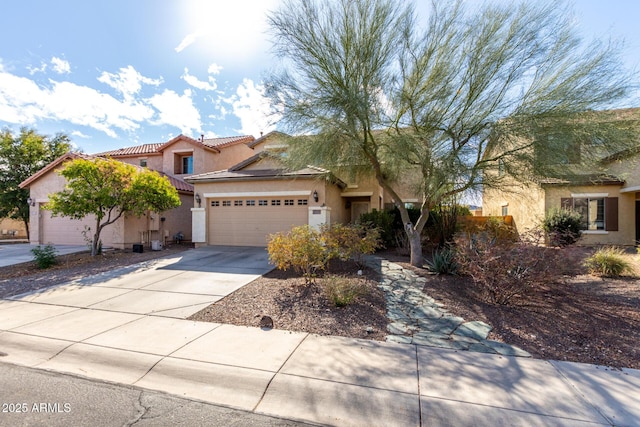 view of front of property featuring a tiled roof, stucco siding, driveway, and an attached garage