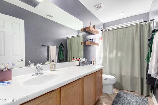 bathroom featuring vanity, tile patterned floors, toilet, and visible vents