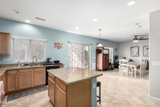 kitchen with light tile patterned floors, visible vents, a kitchen island, a sink, and dishwasher