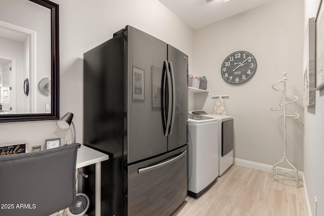 kitchen featuring freestanding refrigerator, independent washer and dryer, and baseboards