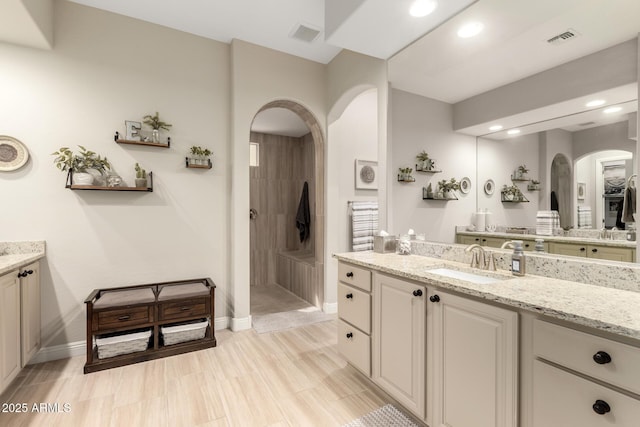 full bath with a walk in shower, vanity, visible vents, and recessed lighting