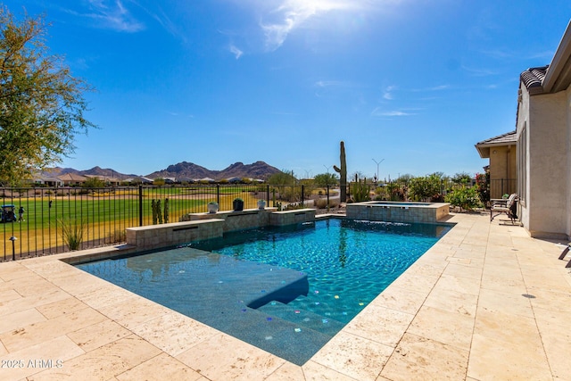 view of pool with a patio, a pool with connected hot tub, a fenced backyard, and a mountain view