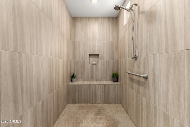 full bath featuring a tile shower