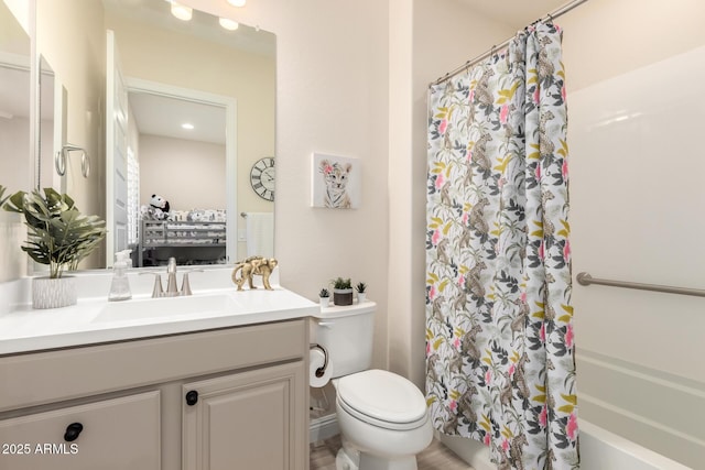 bathroom with toilet, shower / bathtub combination with curtain, and vanity