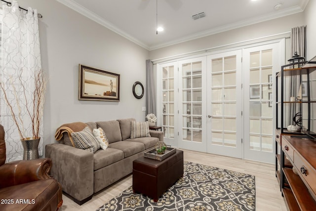 living room featuring visible vents, ornamental molding, french doors, light wood-type flooring, and recessed lighting