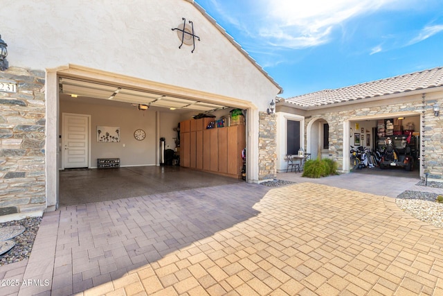 garage featuring decorative driveway and a garage door opener