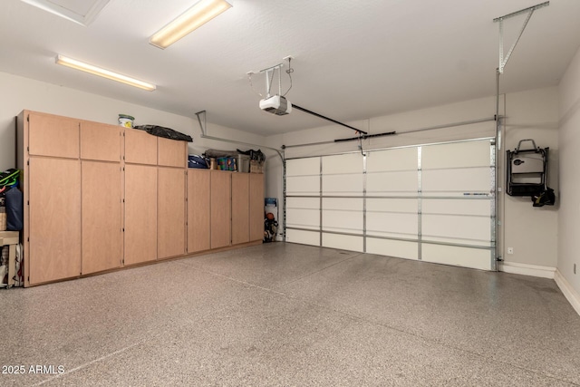 garage with baseboards and a garage door opener