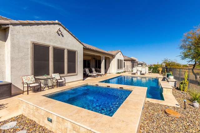 view of swimming pool with an in ground hot tub, a fenced backyard, a fenced in pool, and a patio