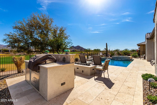 view of pool featuring a patio, exterior kitchen, a grill, and fence