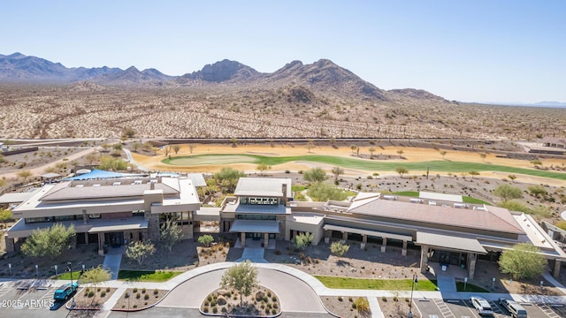 aerial view with view of golf course and a mountain view