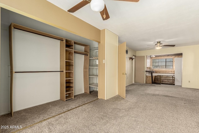 interior space with a ceiling fan, carpet, and a closet