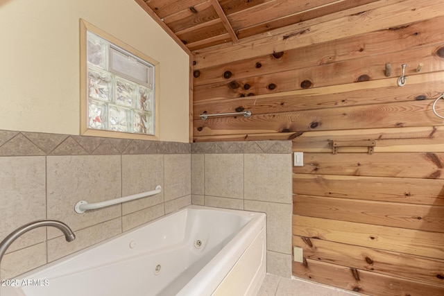 full bath with tile patterned floors, a jetted tub, and wood ceiling