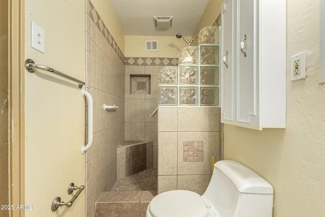 full bath with visible vents, toilet, and walk in shower