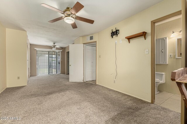 interior space featuring visible vents, carpet floors, and ceiling fan