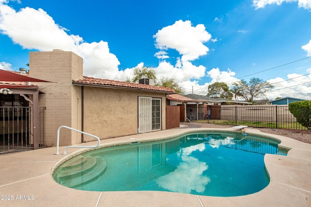 view of pool with a fenced in pool, a patio area, and fence