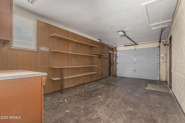 garage featuring wood walls and a garage door opener