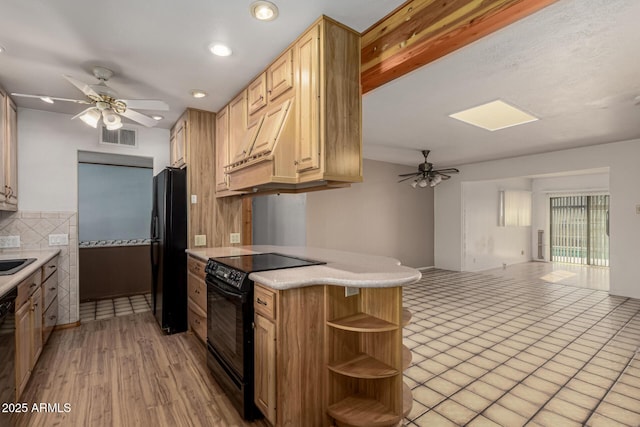 kitchen featuring black appliances, a ceiling fan, open shelves, open floor plan, and a peninsula