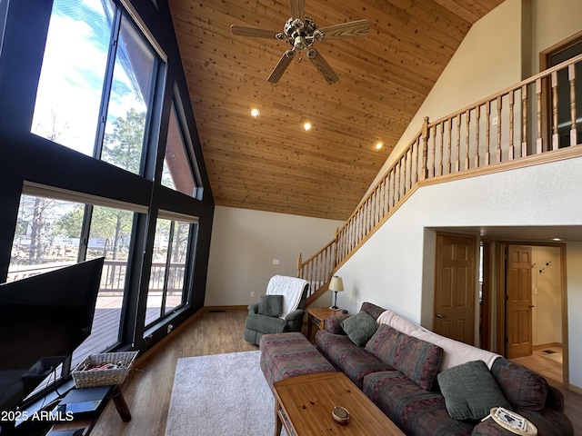 living room with stairway, high vaulted ceiling, ceiling fan, and wooden ceiling