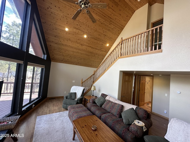 living room with stairway, high vaulted ceiling, wood finished floors, and wooden ceiling