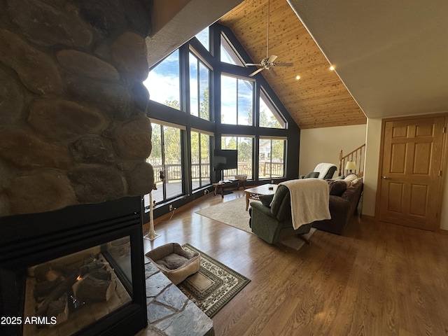living area featuring wood finished floors, high vaulted ceiling, ceiling fan, and wooden ceiling