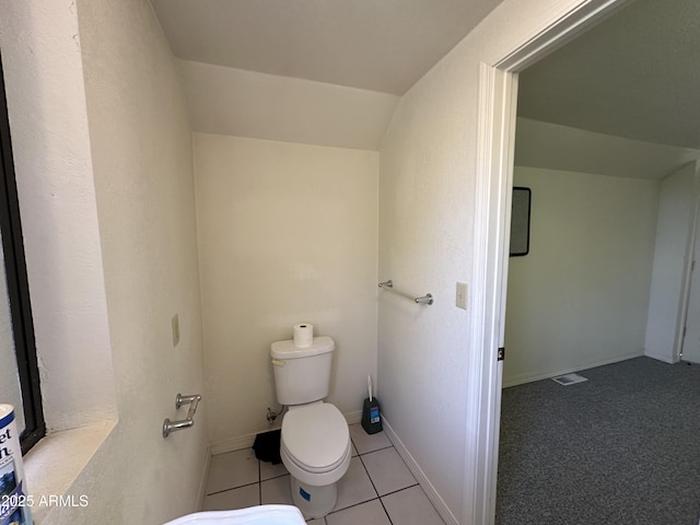 bathroom featuring toilet, tile patterned floors, and baseboards