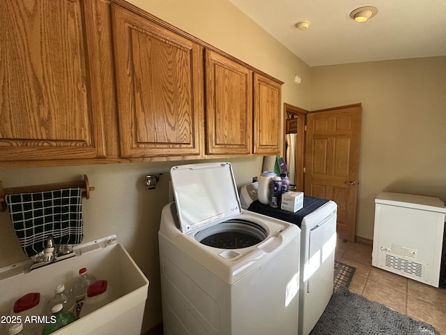 laundry room featuring cabinet space, independent washer and dryer, light tile patterned floors, and a sink