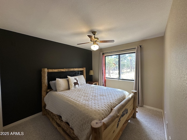 bedroom with ceiling fan, baseboards, and light colored carpet