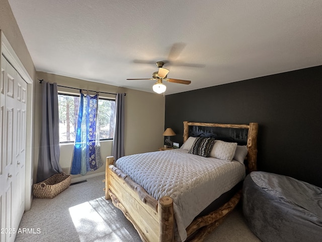 carpeted bedroom with a closet and ceiling fan