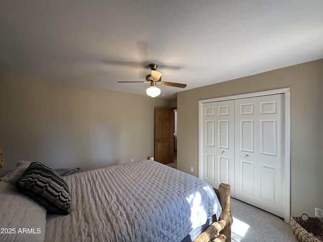 bedroom with a ceiling fan, a closet, and carpet