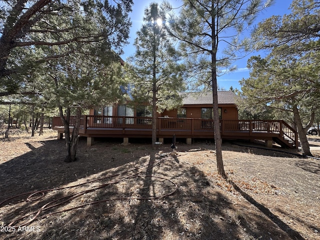 rear view of house with a wooden deck
