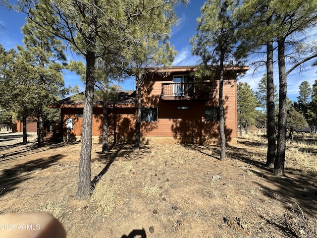 back of property featuring a balcony