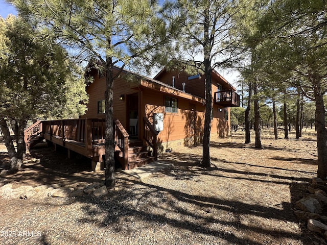 view of side of property featuring a wooden deck