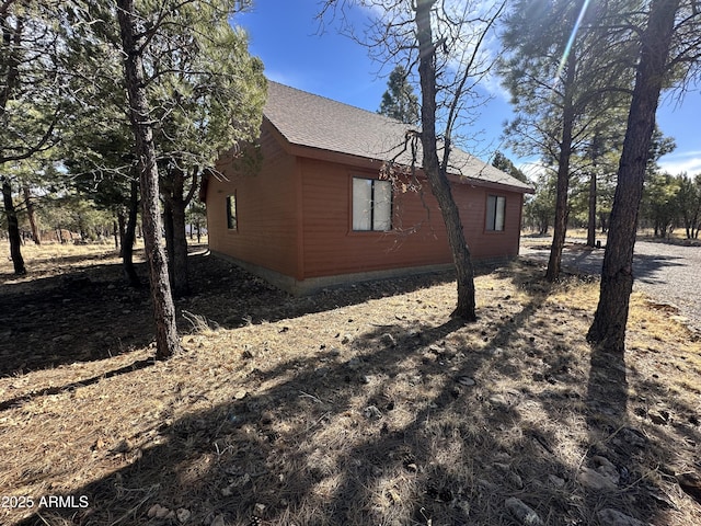 view of property exterior featuring roof with shingles