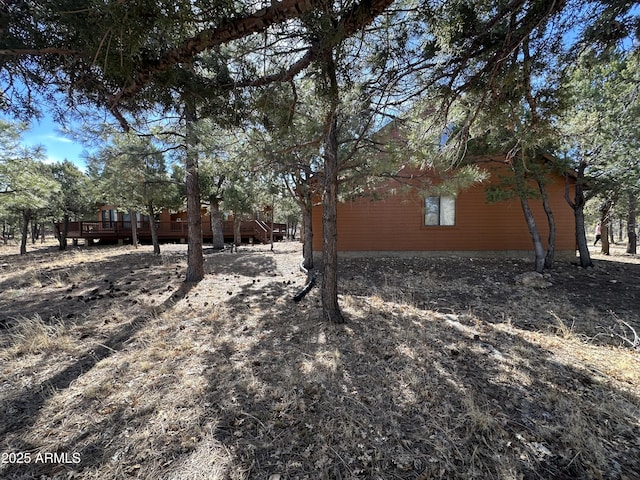 view of side of home with a deck