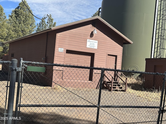 view of outbuilding featuring a gate and fence