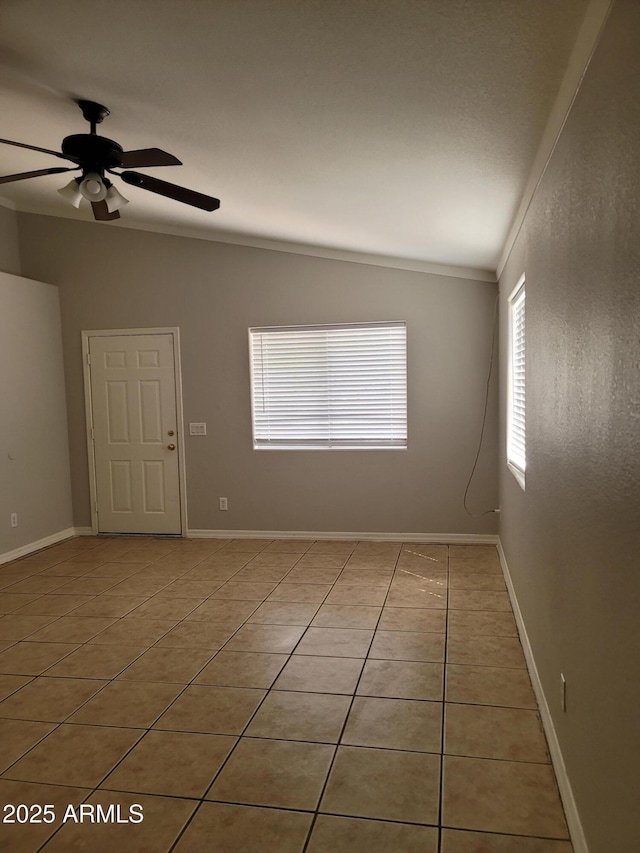 1829 E Adams St, Phoenix, AZ 85034 - unfurnished room featuring vaulted ceiling, crown molding, light tile patterned floors, baseboards, and ceiling fan
