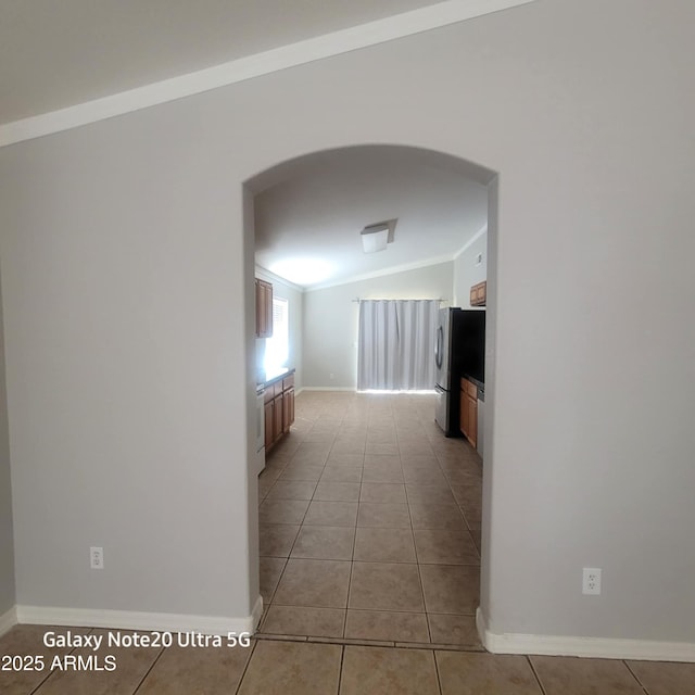 1829 E Adams St, Phoenix, AZ 85034 - hallway featuring baseboards, ornamental molding, tile patterned floors, arched walkways, and lofted ceiling