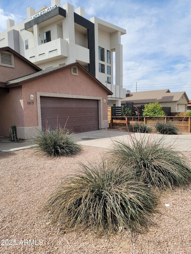 1829 E Adams St, Phoenix, AZ 85034 - view of front of home featuring stucco siding, an attached garage, and driveway